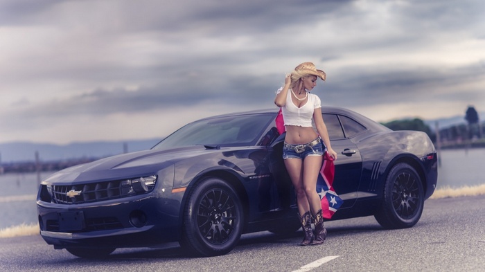 Woman in cowboy hat with a Chevrolet Camaro and Confederate flag