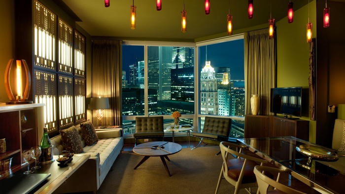 Luxury hotel room with a city view at night