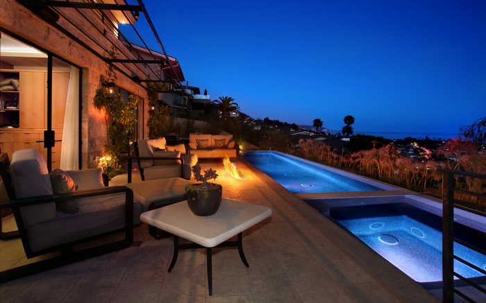Luxury patio with infinity pool at night