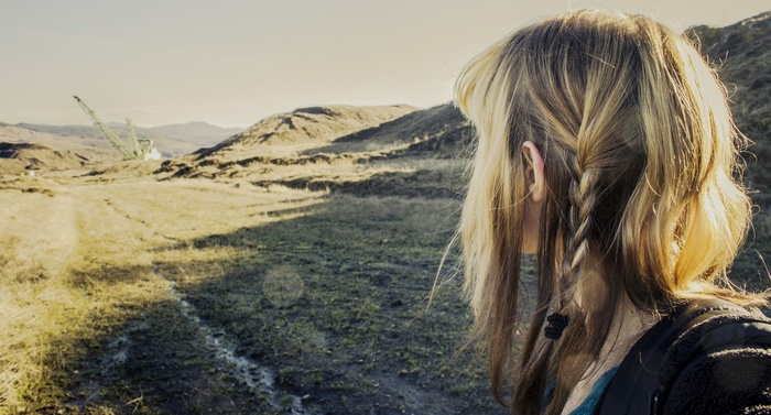 Woman with blonde braids in a natural landscape