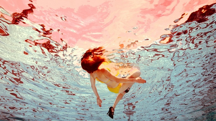 Woman in bikini and high heels underwater