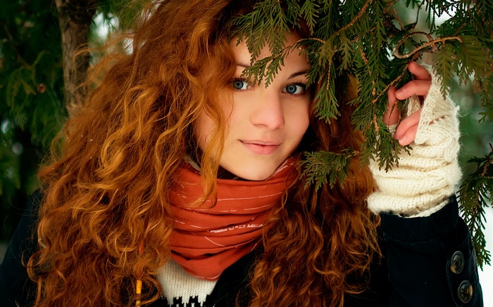 Redhead woman with curly hair and blue eyes in winter