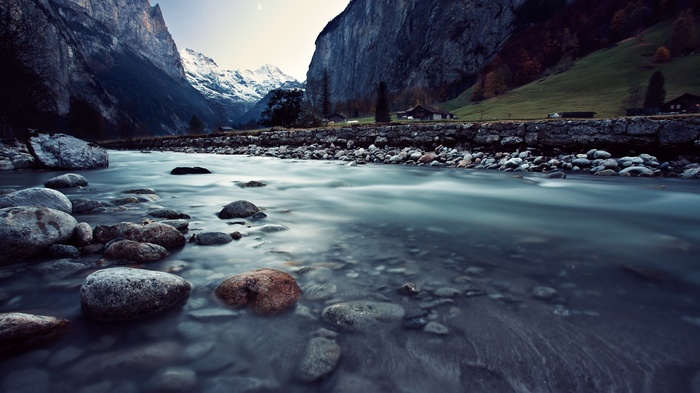 River flowing through a valley with mountains and houses