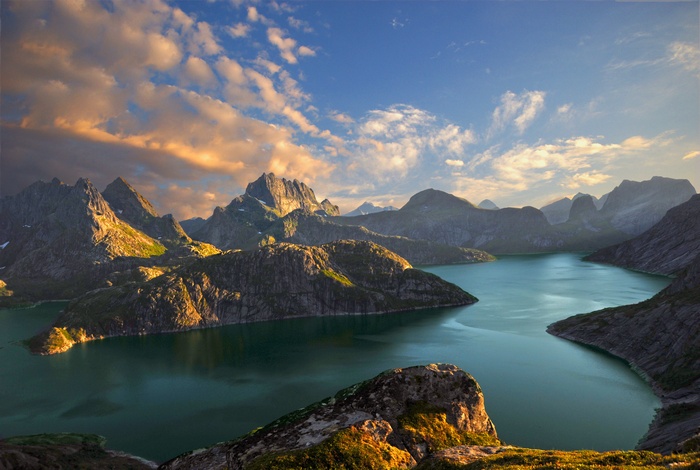 Mountainous landscape with a lake at sunset