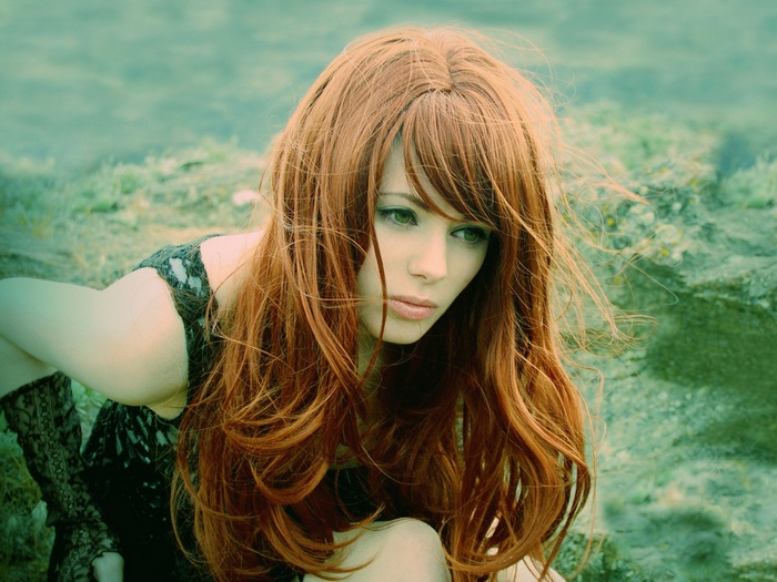 Redhead woman with long hair outdoors