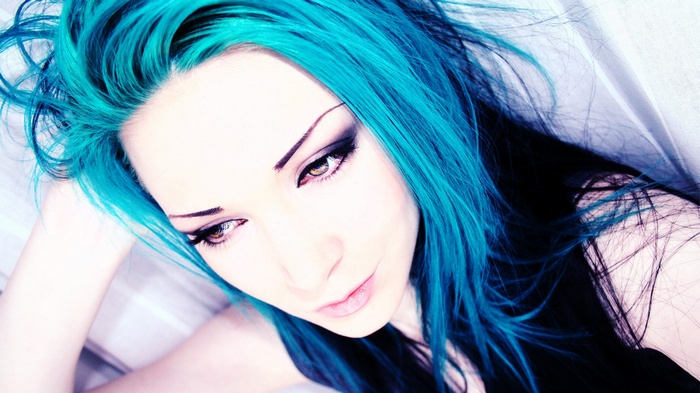 Woman with bright blue hair and dark makeup