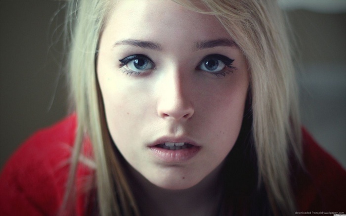Close-up of a young blonde woman with blue eyes
