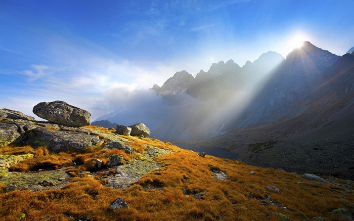 Mountain landscape with sunbeams and rocks
