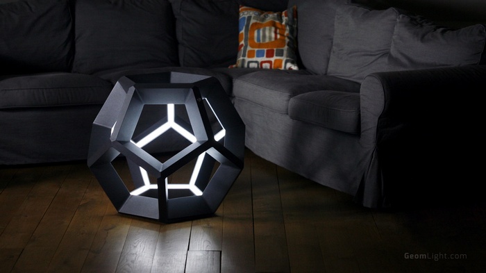 Geometric lamp on wooden floor next to sofa
