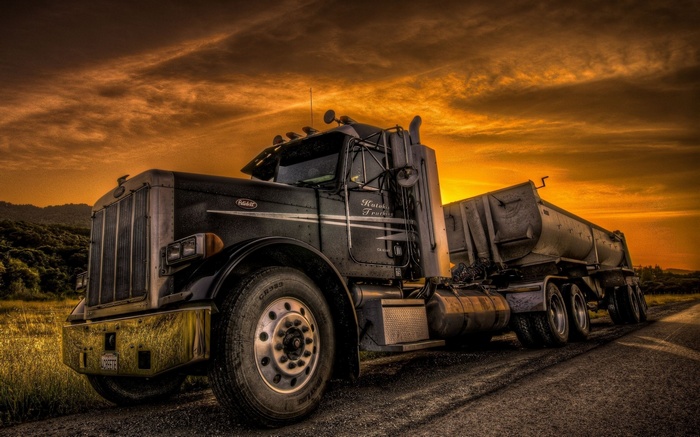 Peterbilt truck with trailer at sunset