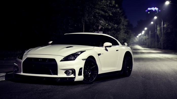 White Nissan GT-R parked on a street at night