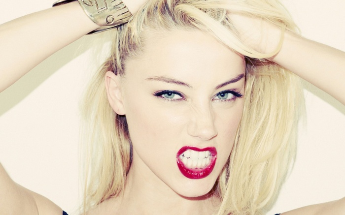 Amber Heard with hands in her blonde hair