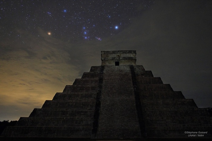Chichen Itza pyramid under the starry night sky in Mexico