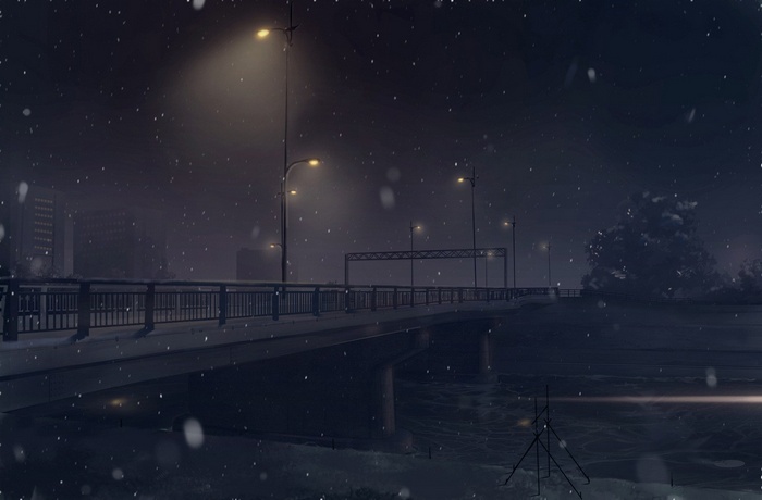 A bridge at night with falling snow