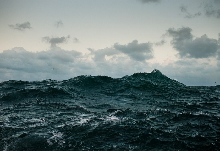 Rough sea with dark waves under a cloudy sky