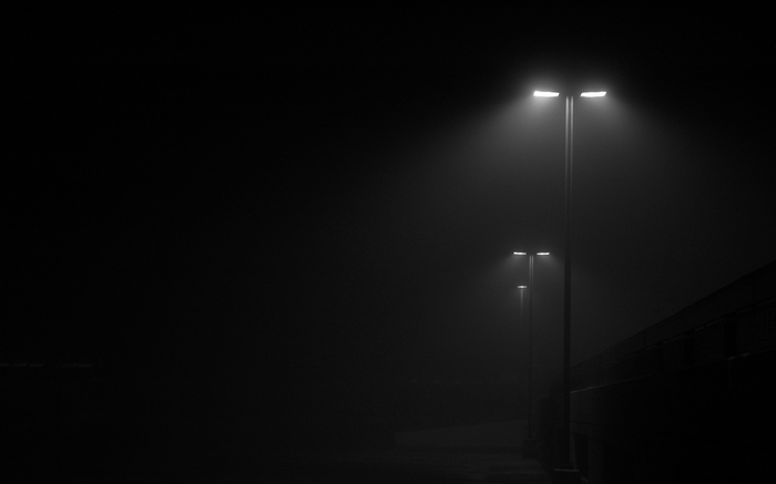 Street lights in the fog at night