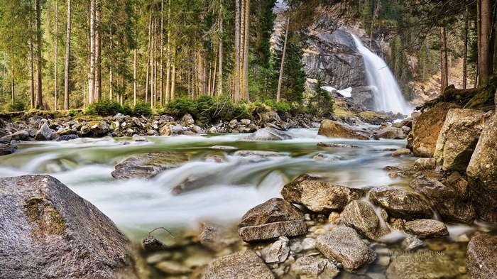 Waterfall in a forest with a river