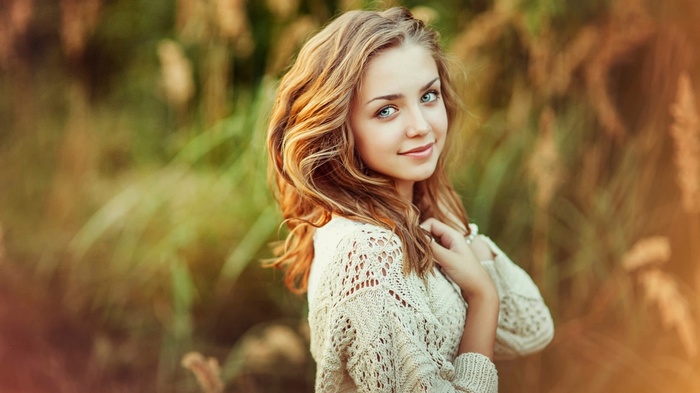 Young woman with blonde hair looking at viewer