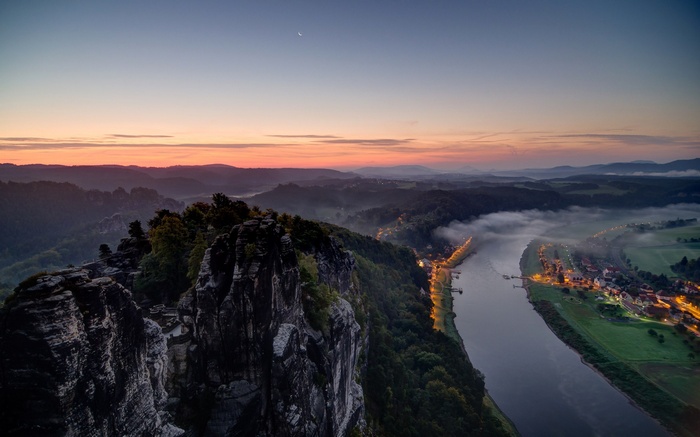 Misty river valley at sunset with rock formations