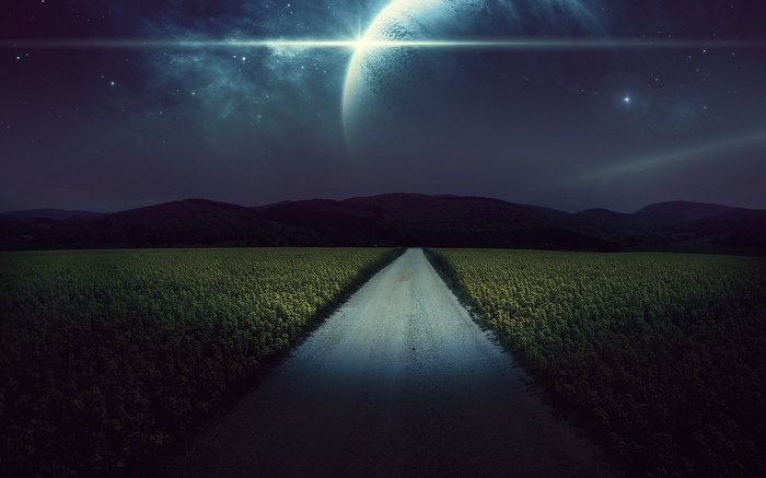 Road through a field under a starry sky with a planet
