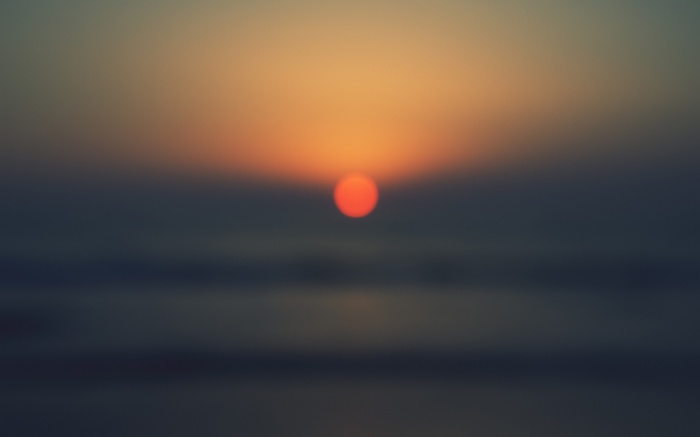 Sunset over the ocean with orange sun