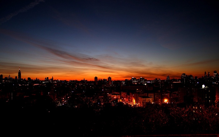 Cityscape at sunset with dramatic sky