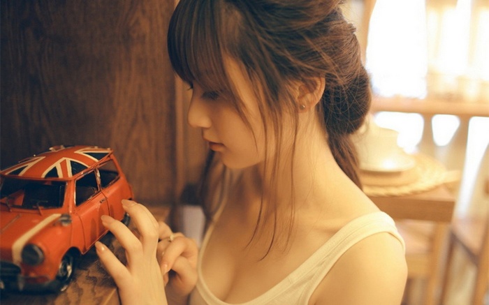 Asian girl with a toy car