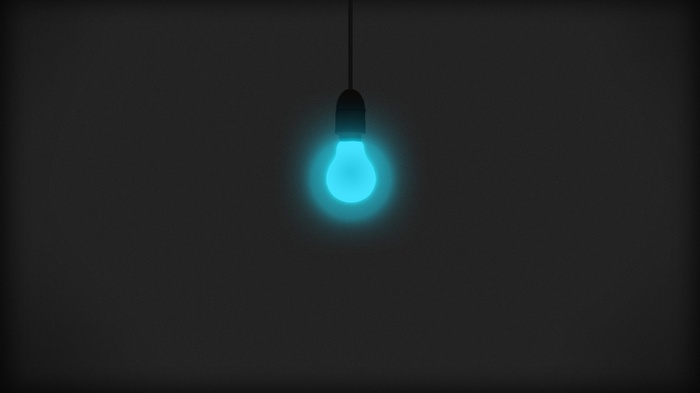 Minimalist blue light bulb hanging in darkness