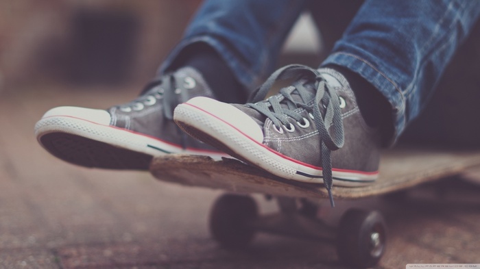Person wearing Converse on a skateboard