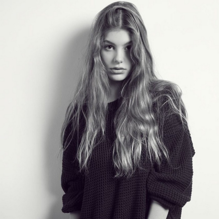 Young blonde woman in a dark sweater