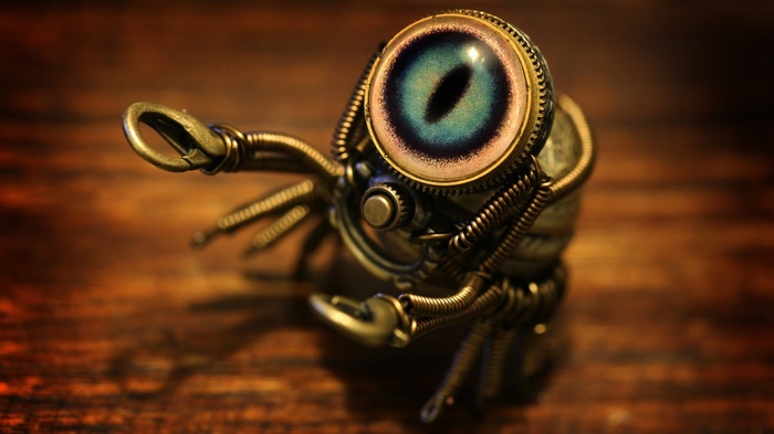 Steampunk spider artwork with a blue eye