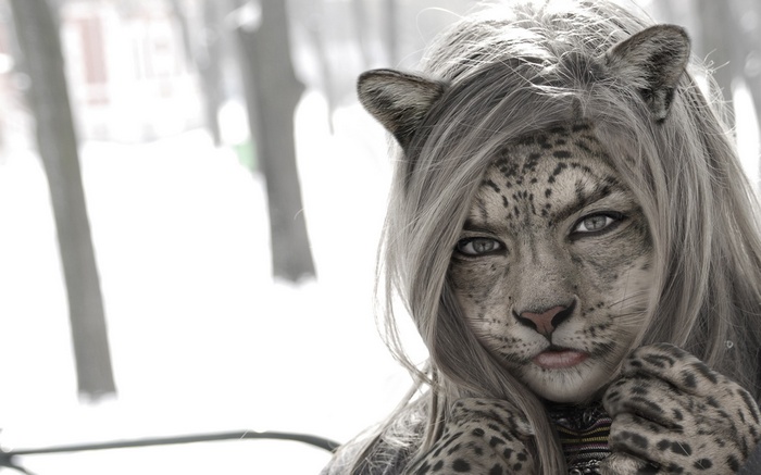 Fantasy girl with leopard face in winter