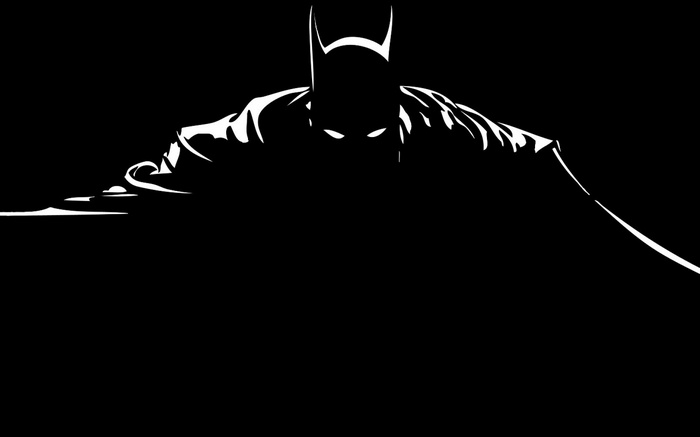 Batman in silhouette with glowing eyes