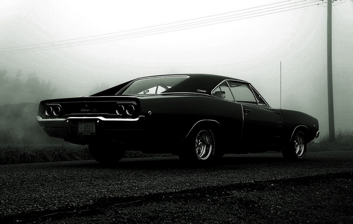 Black 1968 Dodge Charger on a foggy road