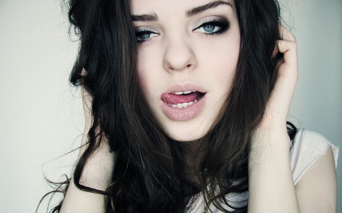 Woman with dark hair and blue eyes