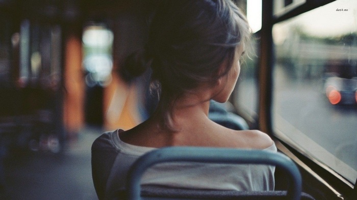 Woman looking out of a bus window