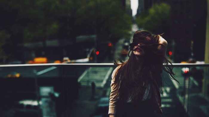 Woman with hair covering her face outdoors