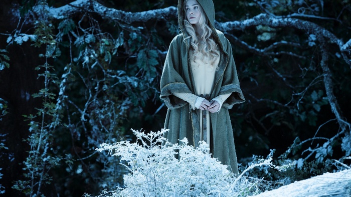 Elle Fanning as Aurora in a snowy forest