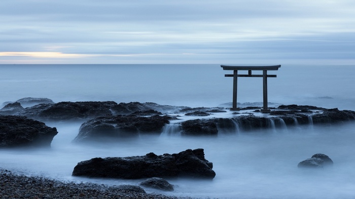 Japanese Torii Gate on Rocky Shoreline