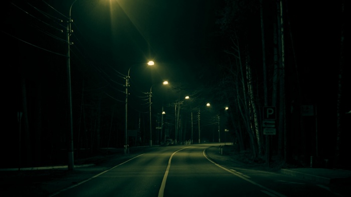 Empty road at night with streetlights