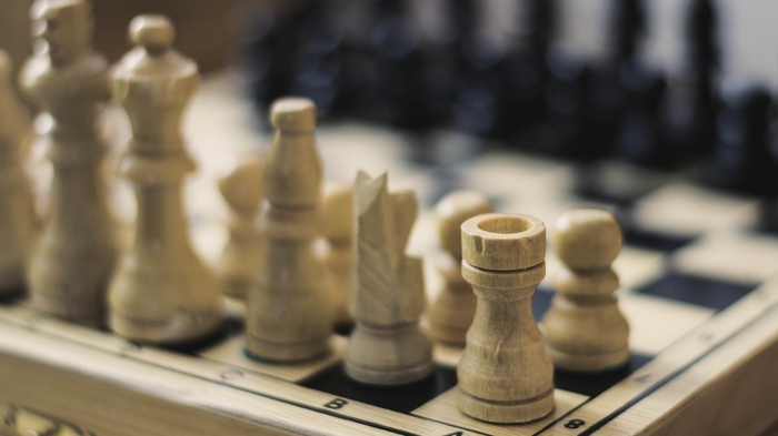 Close-up of a wooden chess set on a board