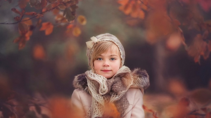 Little girl in autumn forest