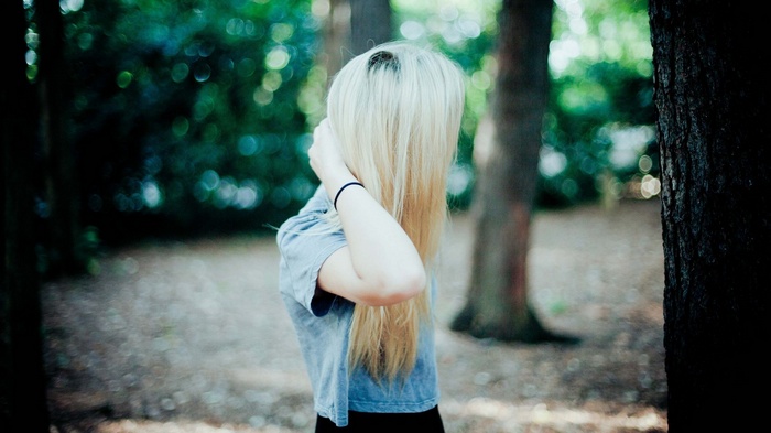 Woman with blonde hair in a forest