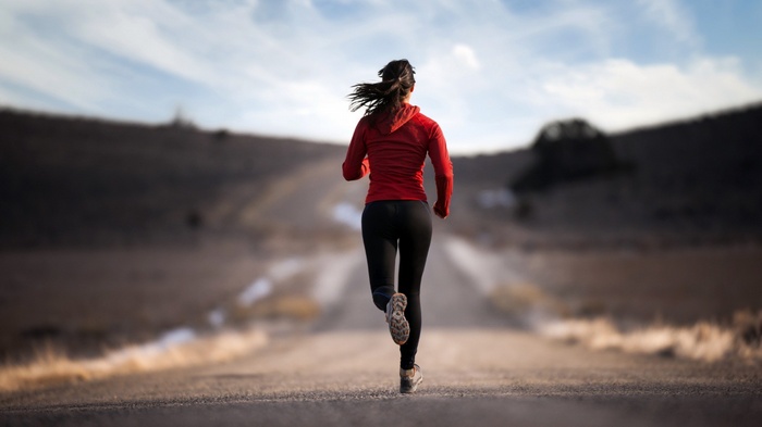 Woman running on a road