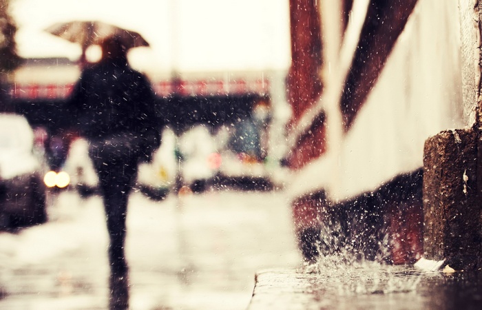 Person with umbrella walking in the rain