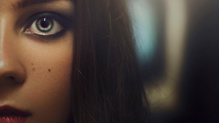 Close-up of a woman's eye and hair