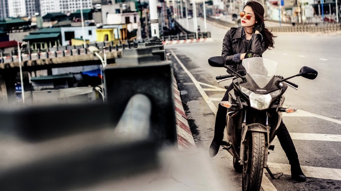 Asian woman with red lipstick on a Honda motorcycle