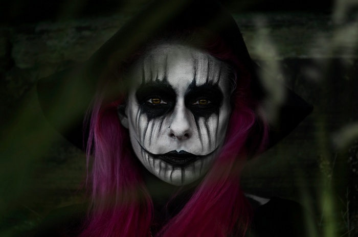 Woman with skull makeup and pink hair