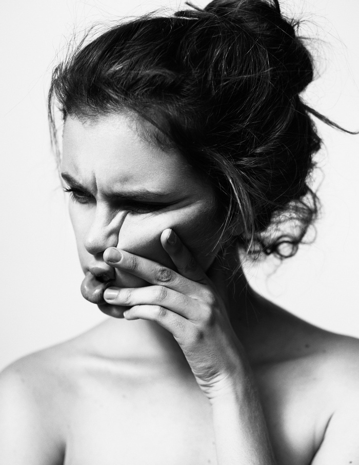 Monochrome portrait of a woman with hand on face