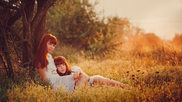 Ann Nevreva and girl in a field at sunset